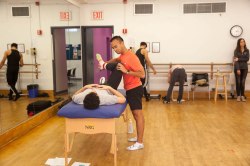 Joshua Honrado at screening table. Photo courtesy of Harkness Center for Dance Injuries.